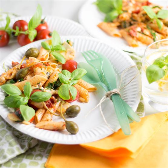 Mediterranean pasta salad with red pesto and pine nuts