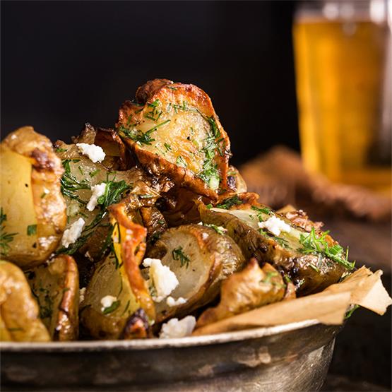 Roasted Jerusalem artichokes with feta and garlic dill butter