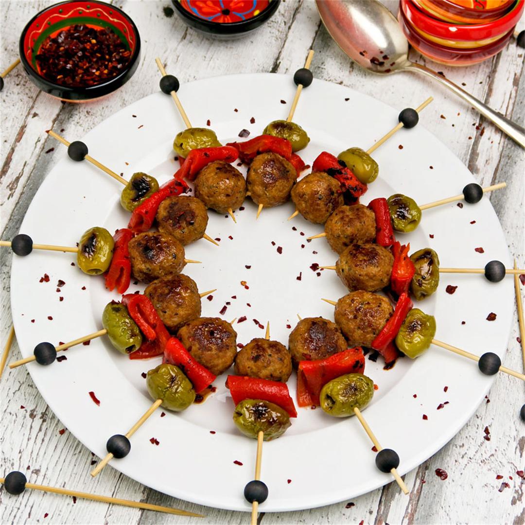 Spanish meatball skewers with grilled olives and red pepper