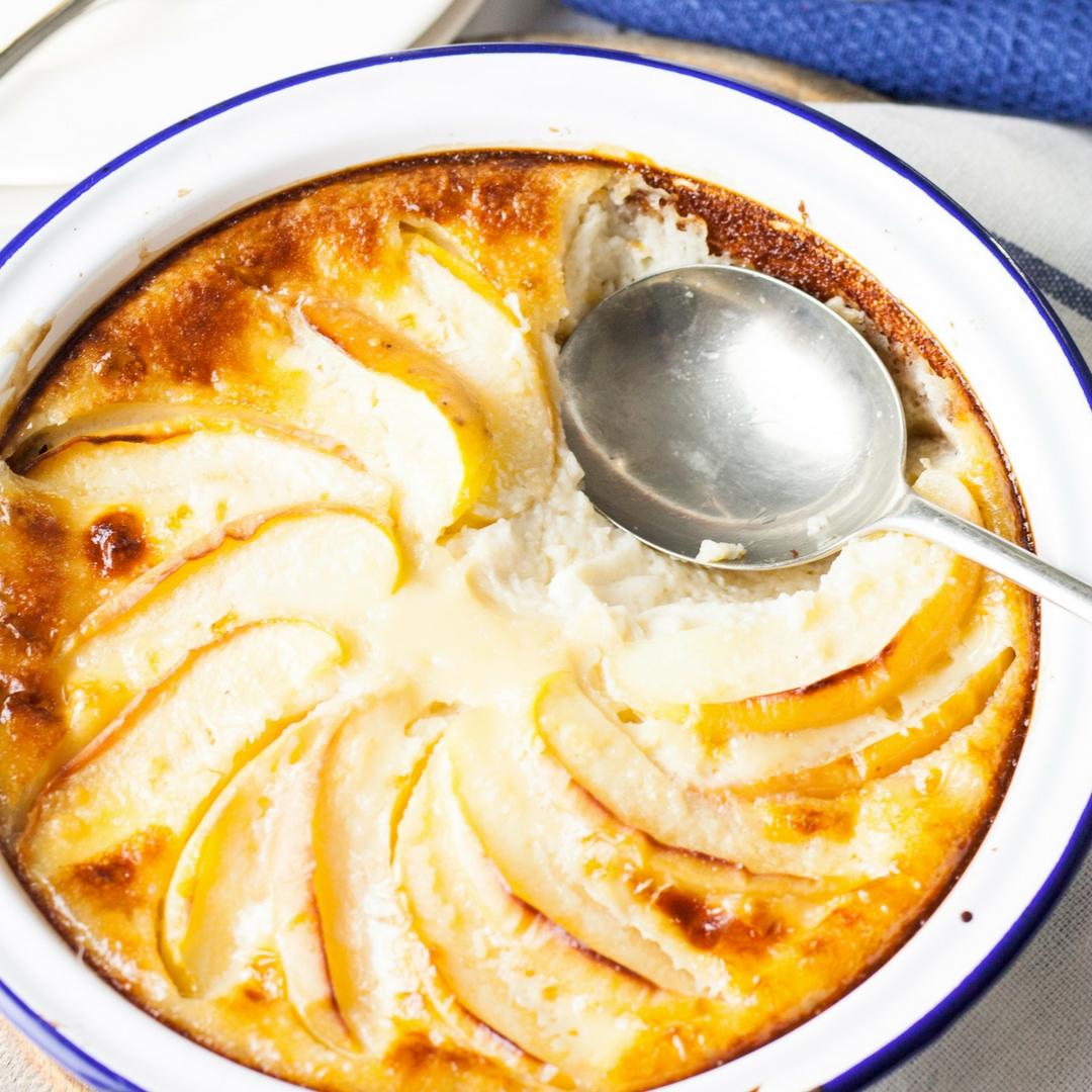 Creamy set custard with brandy, topped with soft baked apple