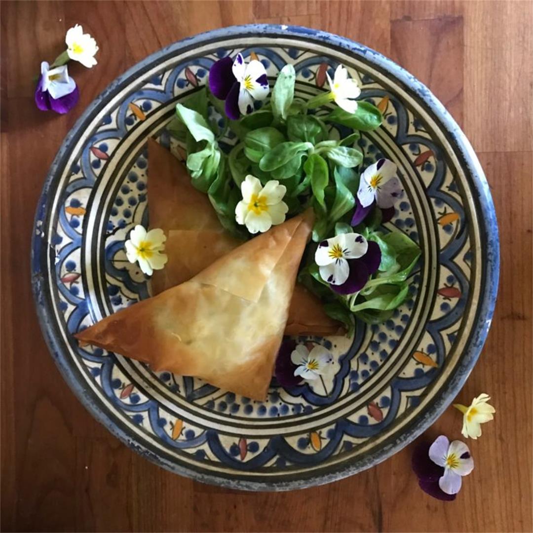 Crispy filo triangles with edible flower salad