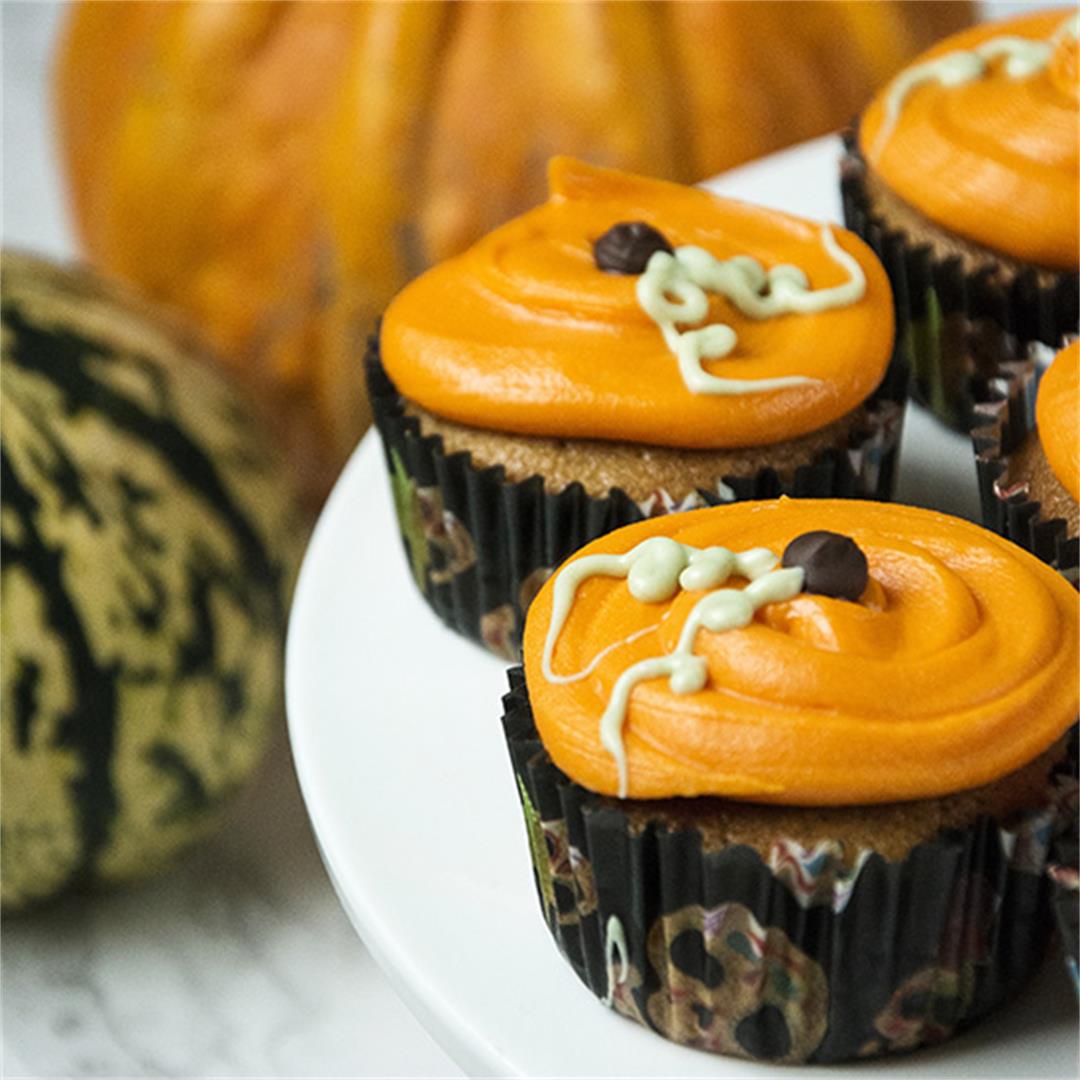 Pumpkin cupcakes decorated with orange white chocolate ganache